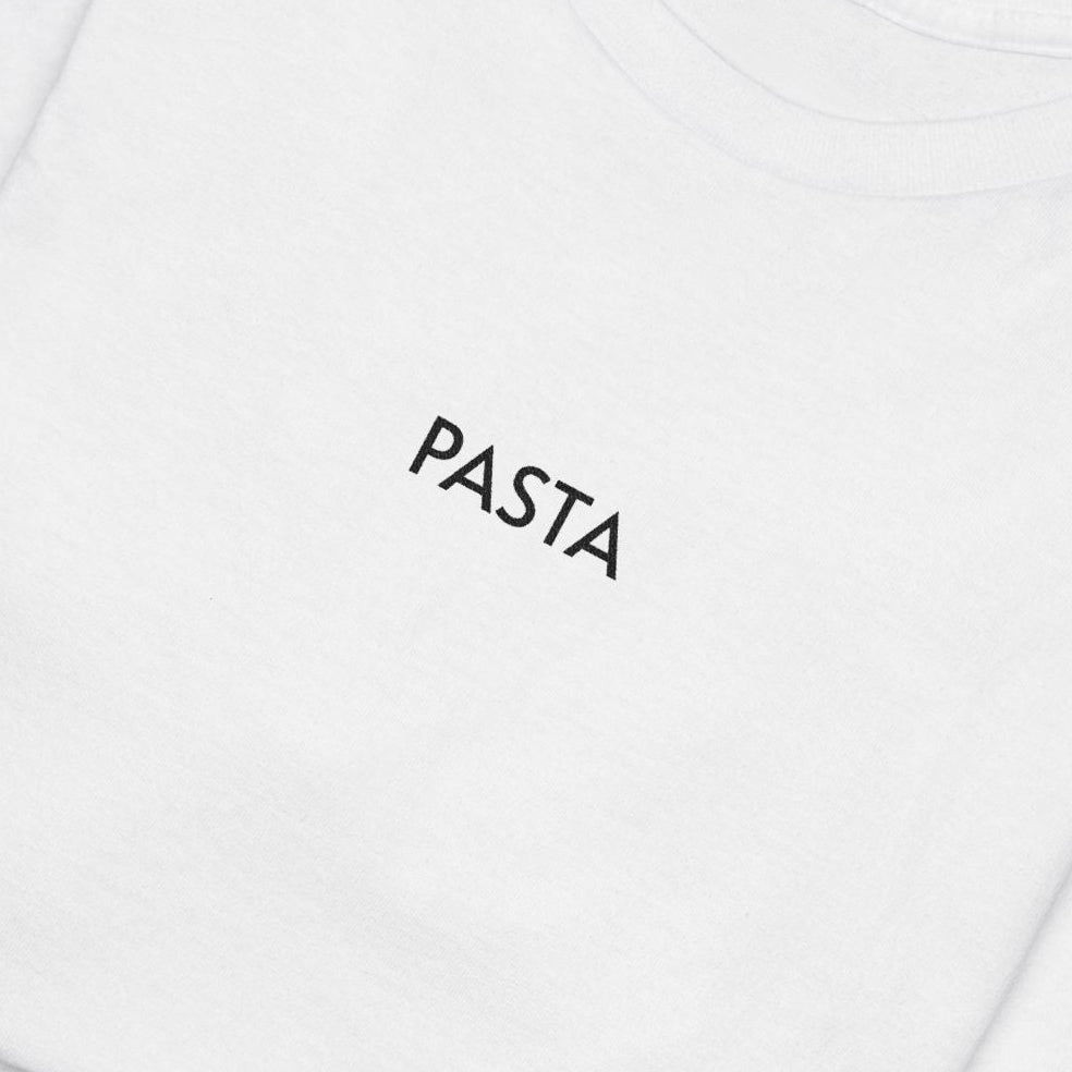 Folded white shirt with text Pasta on a white background